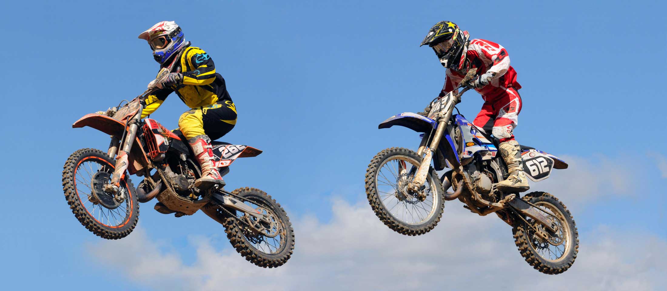 two motocross bikers jumping